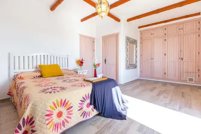 a bedroom with a large bed and a large closet at La Ballena Azul CONIL in Cádiz