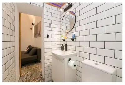 a white bathroom with a sink and a mirror at Casa Cuna in Arcos de la Frontera