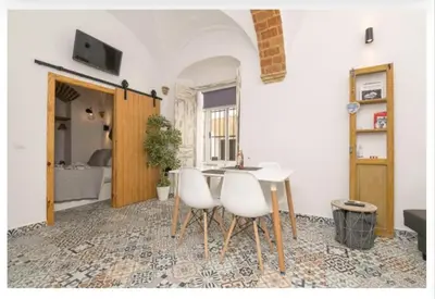 a white door with a reflection of a courtyard at Casa Cuna in Arcos de la Frontera