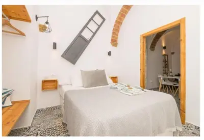 a bedroom with a bed in a white room at Casa Cuna in Arcos de la Frontera