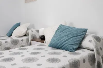 a living room with a couch with a pillow on it at Cielos 57 in El Puerto de Santa María