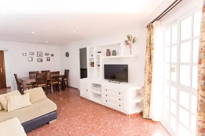 a living room with a couch and a tv at Cielos 57 in El Puerto de Santa María