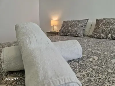 a bed with two pillows on it in a room at Guadalquivir amplio y céntrico in Sanlúcar de Barrameda