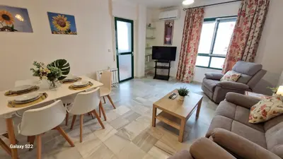 a living room with a couch and a table at Guadalquivir amplio y céntrico in Sanlúcar de Barrameda