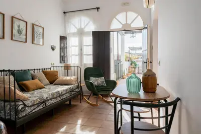 a living room with a couch and a table at La Gitanilla Alojamiento & Encanto Jerez in Jerez de la Frontera