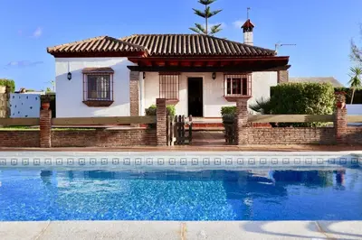 a small house with a pool in front of it at Fuente del Gallo Nomada in Conil de la Frontera