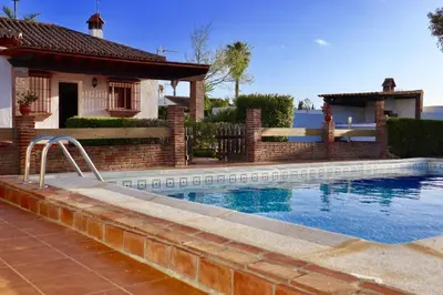 a swimming pool in front of a house at Fuente del Gallo Nomada in Conil de la Frontera