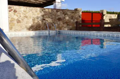 a swimming pool with a water slide at Fuente del Gallo Nomada in Conil de la Frontera