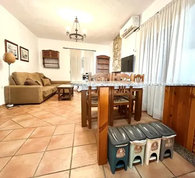 a living room with a table and a couch at Fuente del Gallo Nomada in Conil de la Frontera