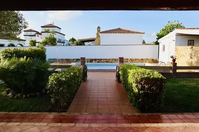 a walkway leading to a pool in a house at Fuente del Gallo Nomada in Conil de la Frontera