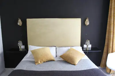 a bedroom with a bed with two pillows at Luxury apartament in Cádiz
