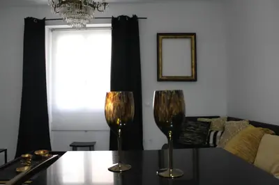 a dining room table with two wine glasses on it at Luxury apartament in Cádiz