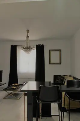 a dining room with a table and chairs and a chandelier at Luxury apartament in Cádiz