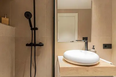 a bathroom with a white sink and a mirror at Allo Apartments Francos II Parking Centro 2 Habitaciones in Jerez de la Frontera