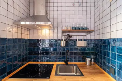 a kitchen with a sink and blue tiles at Allo Apartments Francos II Parking Centro 2 Habitaciones in Jerez de la Frontera