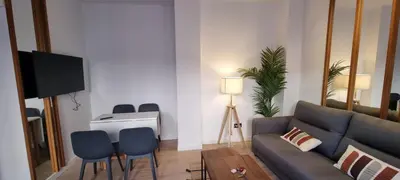 a living room with a couch and chairs and a piano at Allo Apartments Francos II Parking Centro 2 Habitaciones in Jerez de la Frontera