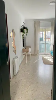 a living room with white walls and a white floor at Apartamento en la playa cruz del mar chipiona in Chipiona