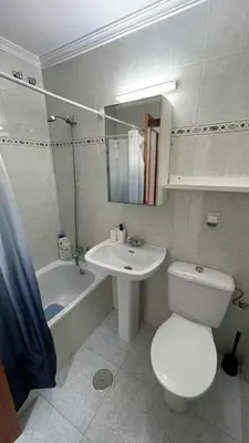 a bathroom with a toilet and a sink and a tub at Apartamento en la playa cruz del mar chipiona in Chipiona