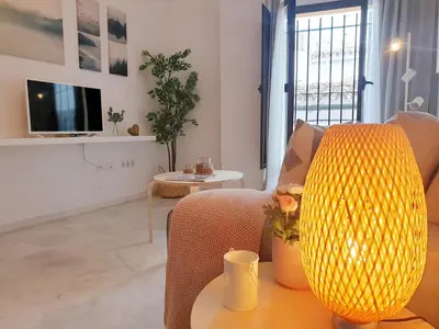 a living room with a table and a yellow lamp at Sherryflat Neira - Parking in Jerez de la Frontera