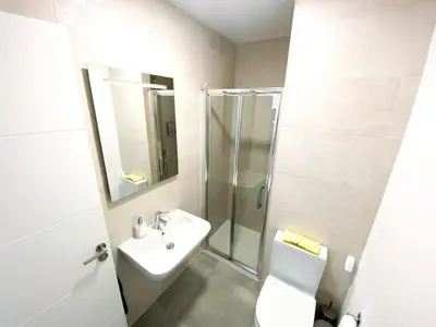 a bathroom with a sink and a shower and a toilet at Casa moderna, piscina, playa, TV75, Netflix, PS4 in Conil de la Frontera