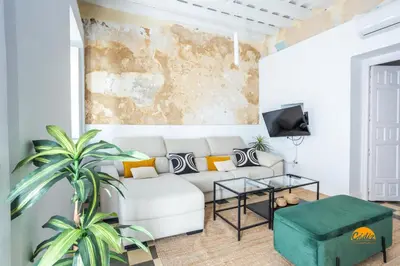 a living room with a couch and a table at La Casa del Alfarero by Cadiz Time in Cádiz