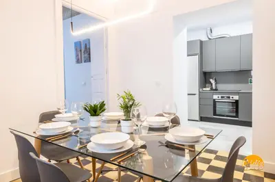 a dining room with a glass table and chairs at La Casa del Alfarero by Cadiz Time in Cádiz