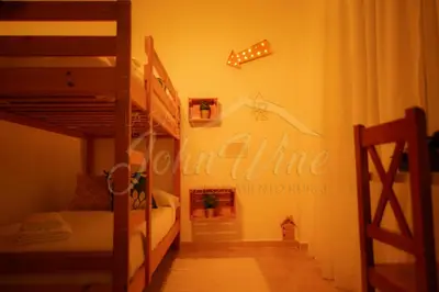 a bedroom with two bunk beds and a sign that reads wine at La casa de John Wine , Bornos (Spain) in Bornos