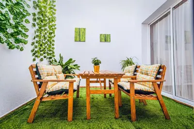 a wooden table and two chairs on a balcony at La casa de John Wine , Bornos (Spain) in Bornos