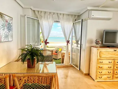 a living room with a view of the ocean at Ático Good Vibes in Rota