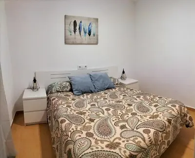 a bedroom with a bed and two night stands at Twins' Home Ponce, Jerez Centro, Cádiz, wifi in Jerez de la Frontera