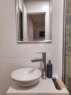 a bathroom with a white sink and a mirror at Twins' Home Ponce, Jerez Centro, Cádiz, wifi in Jerez de la Frontera