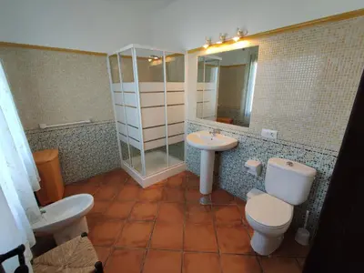 a bathroom with a toilet and a sink and a mirror at Casa Antonia in Conil de la Frontera