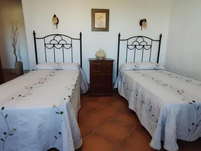 two beds sitting next to each other in a room at Casa Antonia in Conil de la Frontera