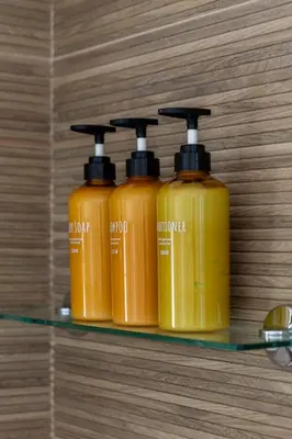 three mustard bottles sitting on a glass shelf at Victoria Seis in Medina Sidonia