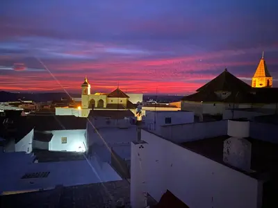 a view of a city at night with a church at Victoria Seis in Medina Sidonia