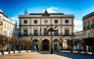 a building with a clock on the front of it at Victoria Seis in Medina Sidonia