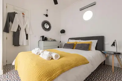 a bedroom with a large bed with towels on it at Victoria Seis in Medina Sidonia