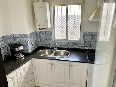 a kitchen with a sink and a window at Apartamentos turísticos en Jerez de la frontera in Jerez de la Frontera