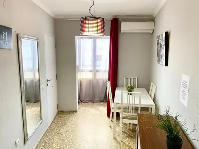 a dining room with a table and a window at Apartamentos turísticos en Jerez de la frontera in Jerez de la Frontera