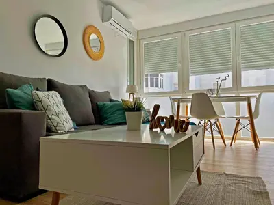 a living room with a couch and a table at Apartamento Aurora - Ole Solutions in El Puerto de Santa María