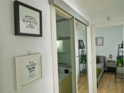 a room with a mirror and a room with a bed at Apartamento Aurora - Ole Solutions in El Puerto de Santa María