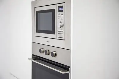a microwave oven sitting on top of a stove at Loft en el corazón de Cádiz con opción a Parking in Cádiz