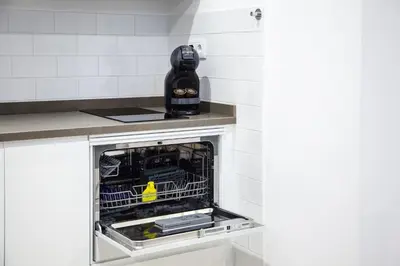 a dishwasher with its door open in a kitchen at Loft en el corazón de Cádiz con opción a Parking in Cádiz