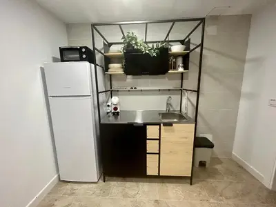 a small kitchen with a sink and a refrigerator at Apartamentos Los Cabezuelos, Dream Views in Arcos de la Frontera