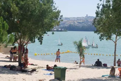 a group of people on a beach with the water at Apartamentos Los Cabezuelos, Dream Views in Arcos de la Frontera