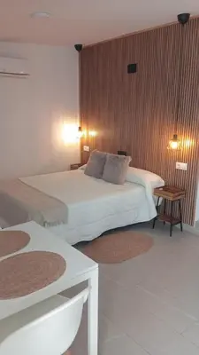 a hotel room with two beds and a table at Apartamentos Los Cabezuelos, Dream Views in Arcos de la Frontera