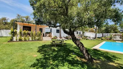a house with a pool and a tree in the yard at VILLA OASIS | Casa Rural ideal Familias y grupos in Arcos de la Frontera