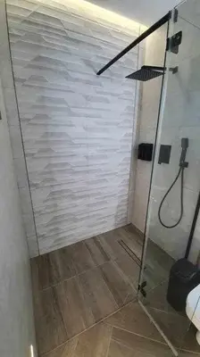 a shower with a glass door in a bathroom at VILLA OASIS | Casa Rural ideal Familias y grupos in Arcos de la Frontera
