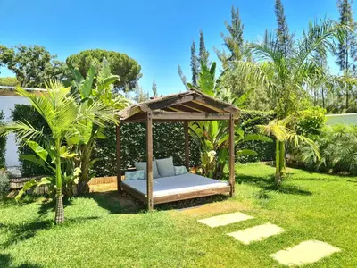a bed in a gazebo in a yard at VILLA OASIS | Casa Rural ideal Familias y grupos in Arcos de la Frontera