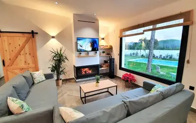 a living room with a couch and a fireplace at VILLA OASIS | Casa Rural ideal Familias y grupos in Arcos de la Frontera